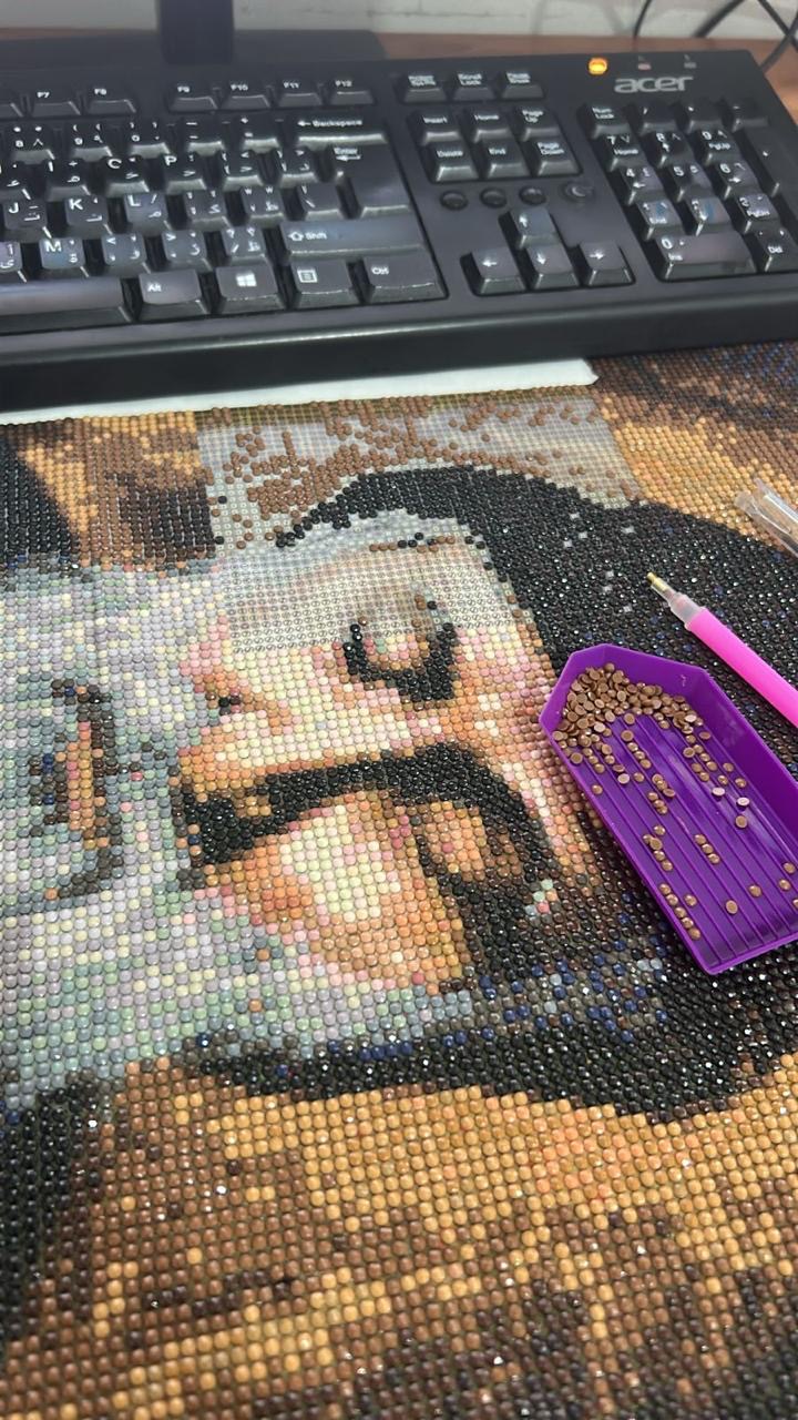 Diamond painting in progress on a desk